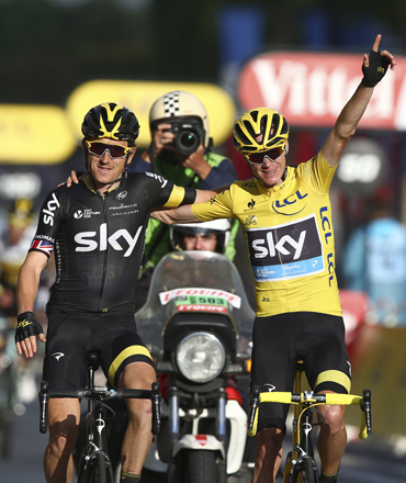 Tour de France winner Britain’s Chris Froome, wearing the overall leader’s yellow jersey, rides arm-in-arm with teammate Britain’s Geraint Thomas as he crosses the finish line of the twenty-first and last stage of the Tour de France cycling race over 109.5 kilometres with start in Sevres and finish in Paris, on Sunday (AP photo)
